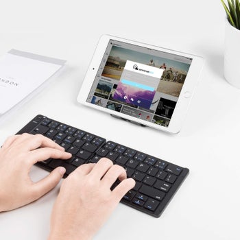 A person using the keyboard to type on their iPad