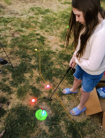 reviewer playing with golf set