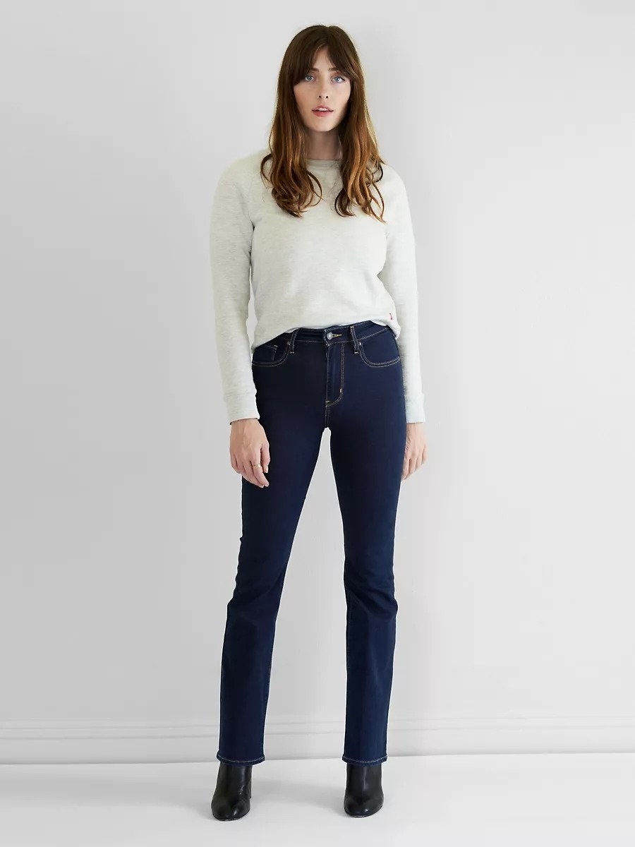 model wearing dark high-rise bootcut jeans
