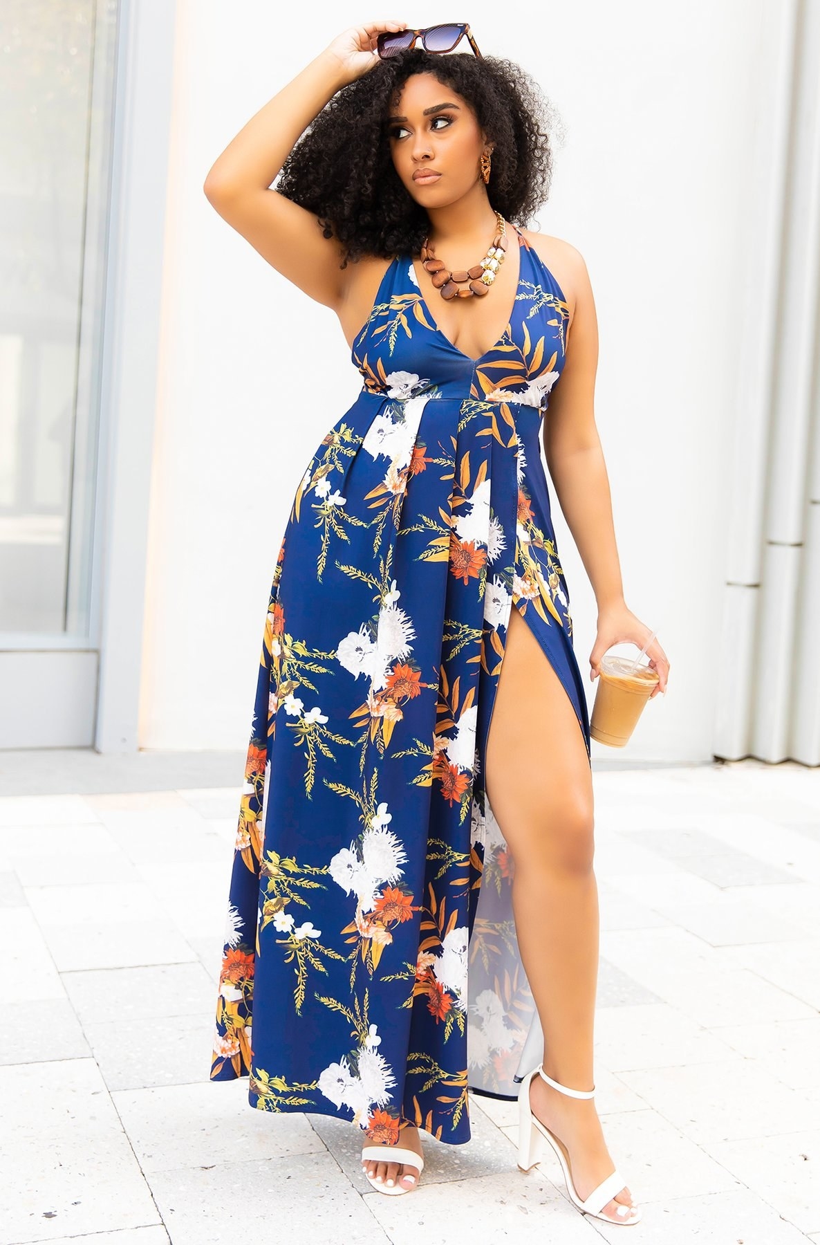 a plus size model wearing the blue floral halter maxi dress