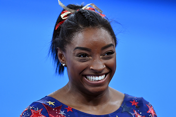 Simone Biles is pictured smiling during the artistic gymnastic women's qualifying rounds at the Tokyo 2020 Olympic Games