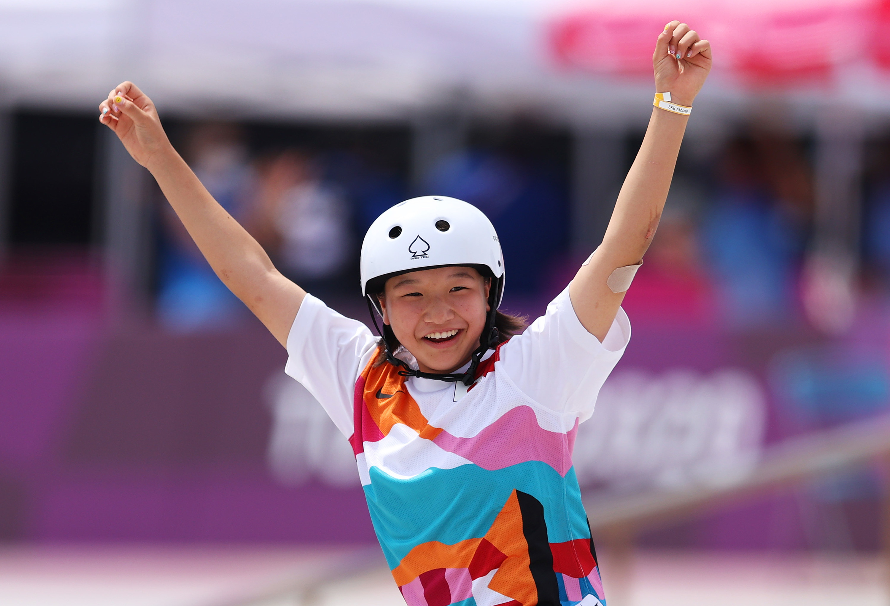 Momiji Nishiya raising arms and smiling