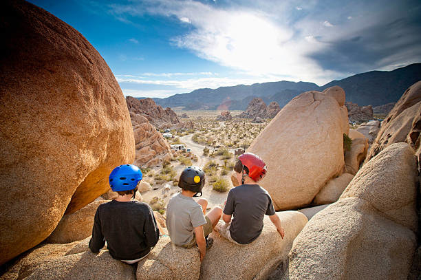 Three kids rock climbing