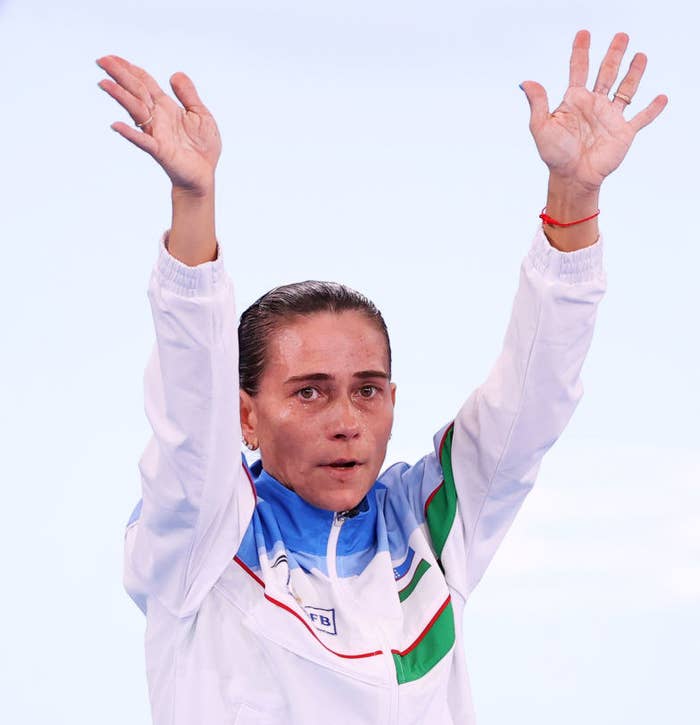 Oksana acknowledging the crowd with her arms raised in the air