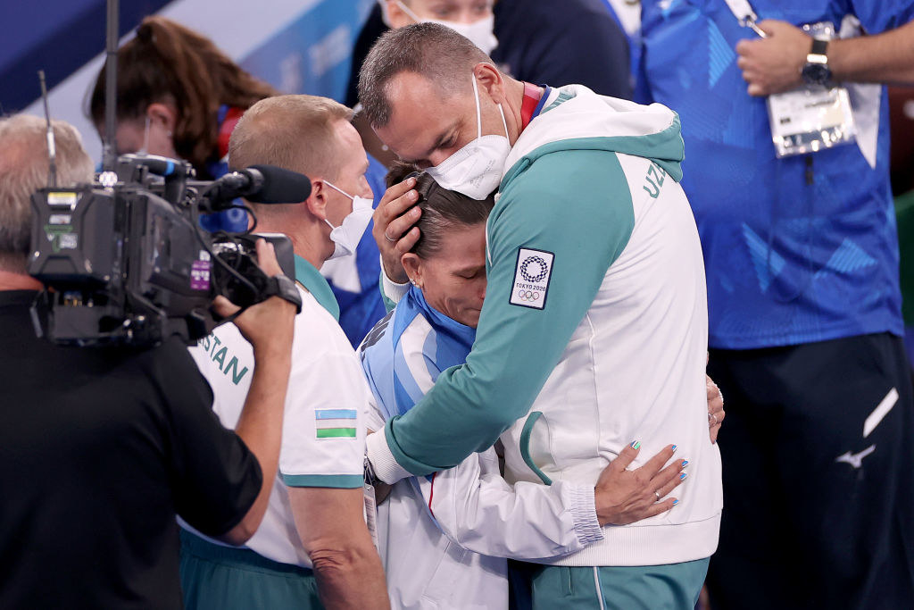 Oksana emotionally hugging a coach