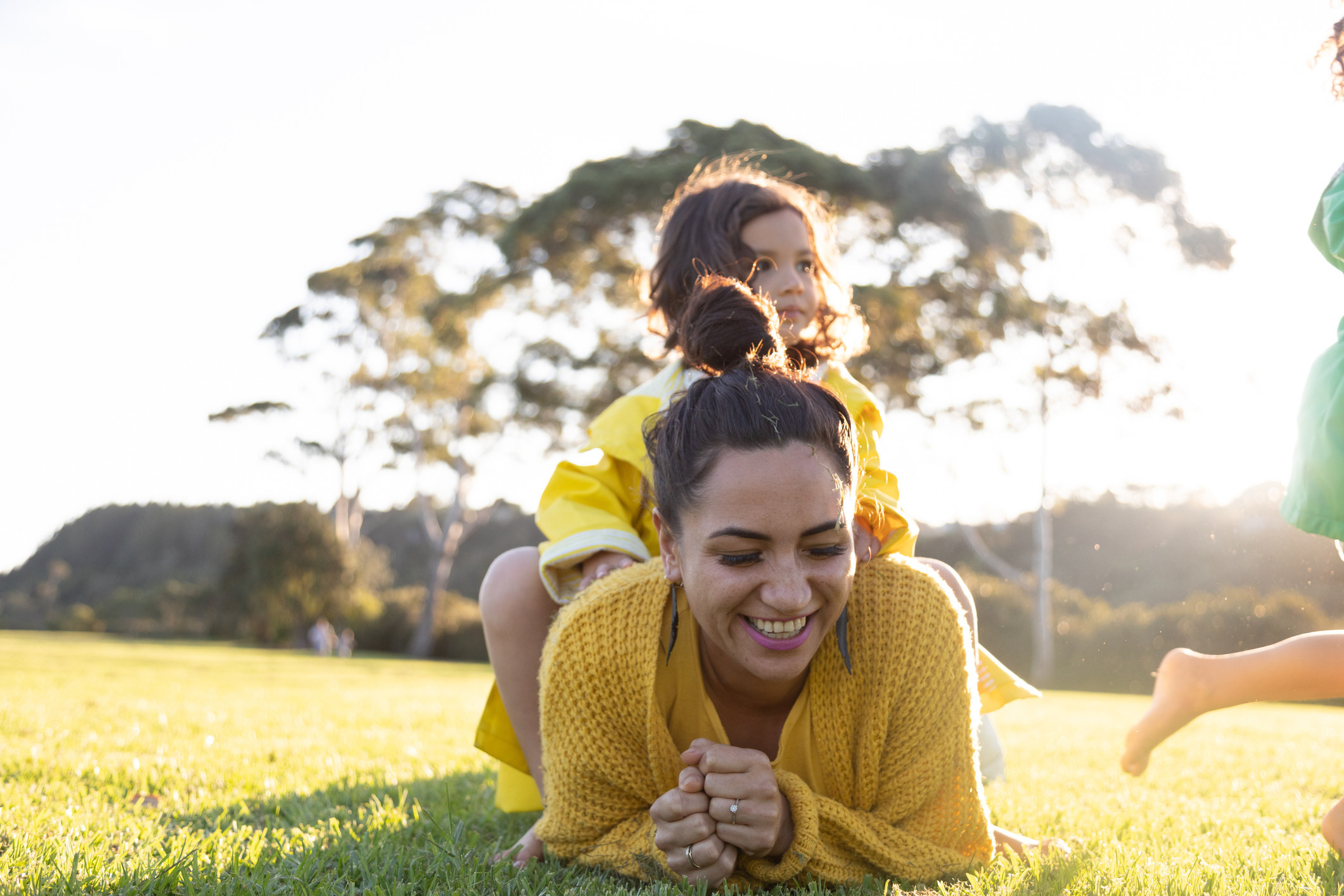 Mother and daughter relaxing in the grass