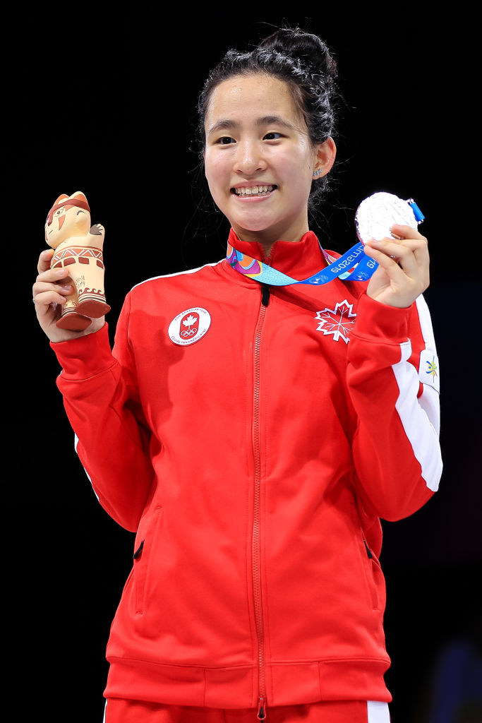 Jessica Zi Jia Guo of Canada smiles as she poses with her medal in 2019