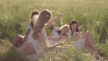 Girls lying in tall grass