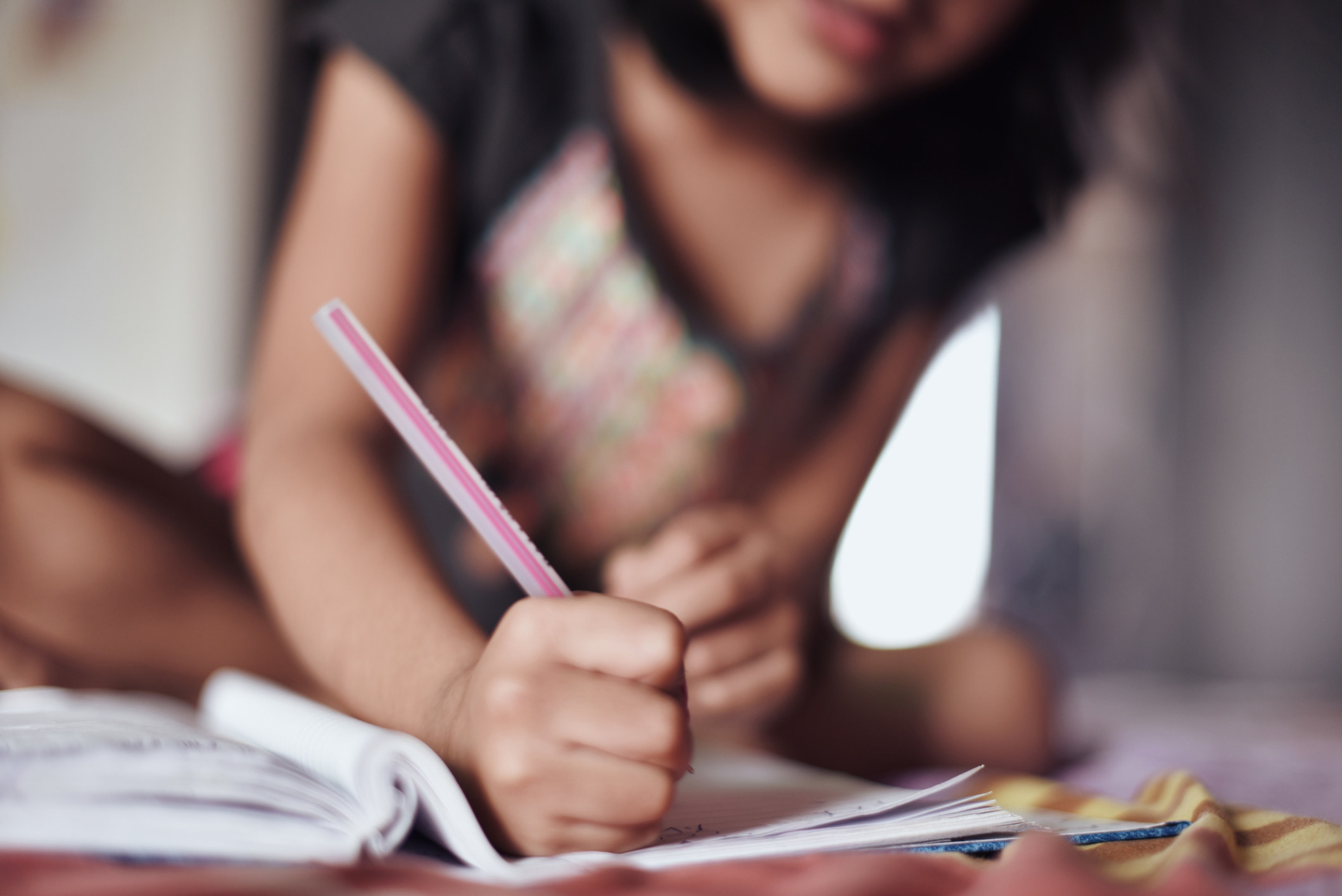 A girl writing in a notebook