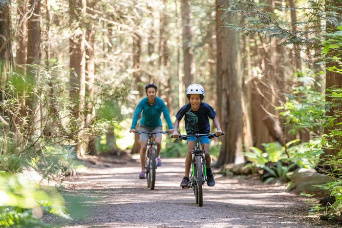 A family riding bikes on a trail