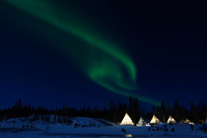 Northern lights sky with tents in the foreground