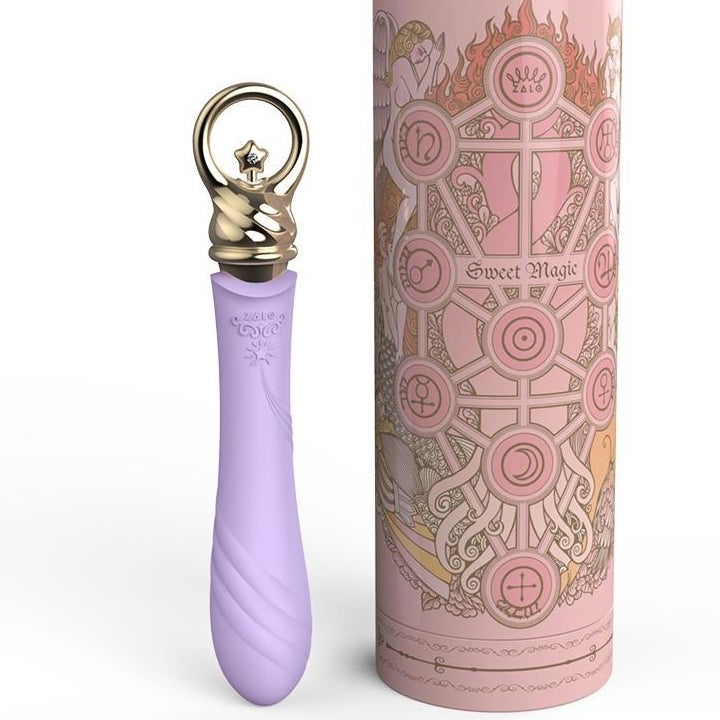 Purple and gold vibrator next to pink case