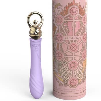 Purple and gold vibrator next to pink case