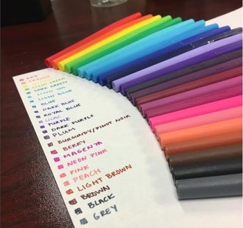 Reviewer's photo showing the markers in an array of colors with the colors noted in their handwriting