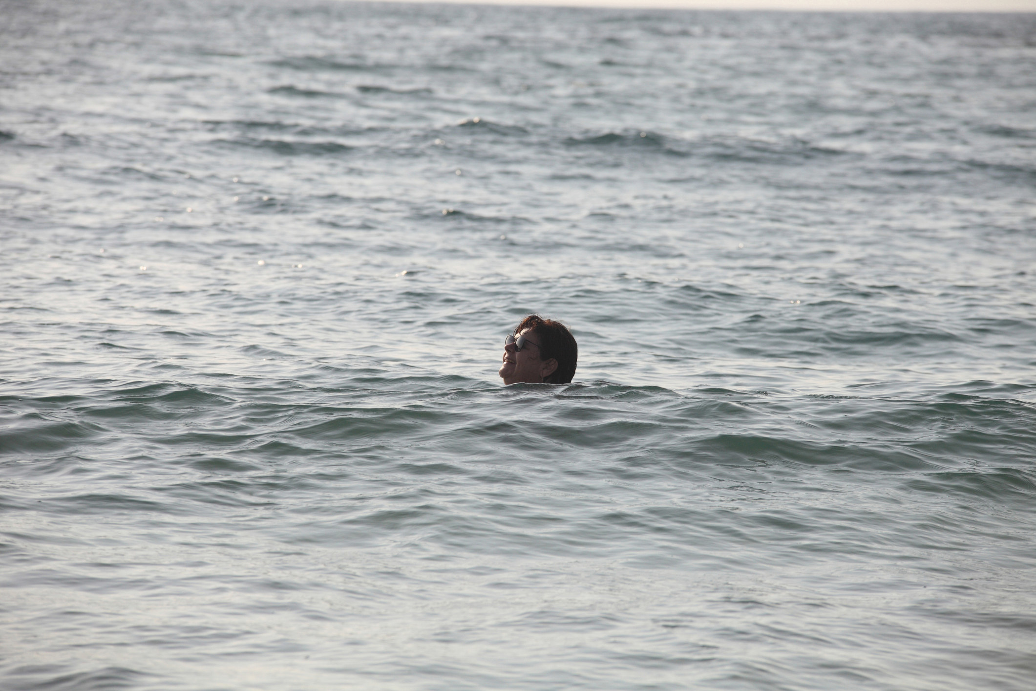 A person floating in the middle of the ocean alone