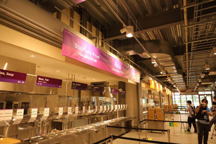A view of the food stations with a banner that says Asia