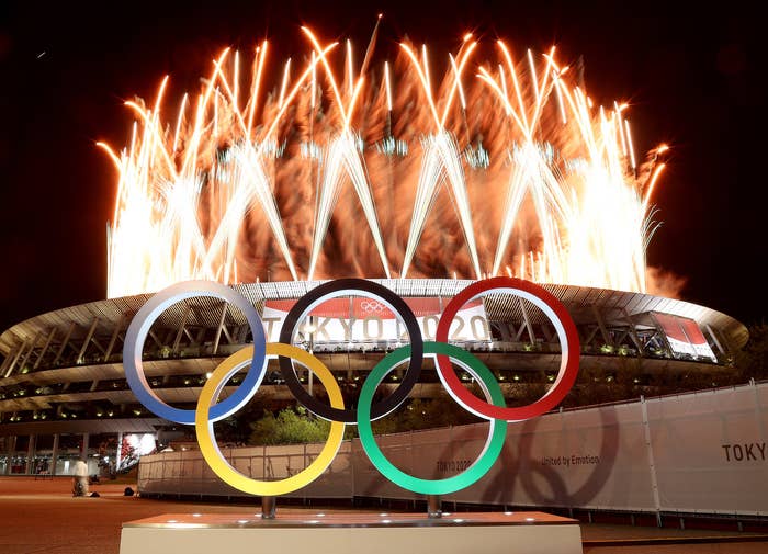 The Olympic rings sit outside the stadium in Tokyo in the middle of a fireworks display