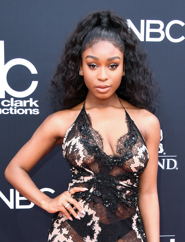 Normani attends the 2018 Billboard Music Awards in a lace-y see-through dress and her hair in a high ponytail