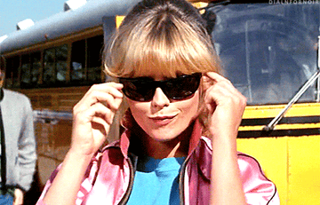 Michelle Pfeiffer adjusting her sunglasses