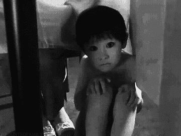 the creepy ghost boy from the grudge staring at you from under a table