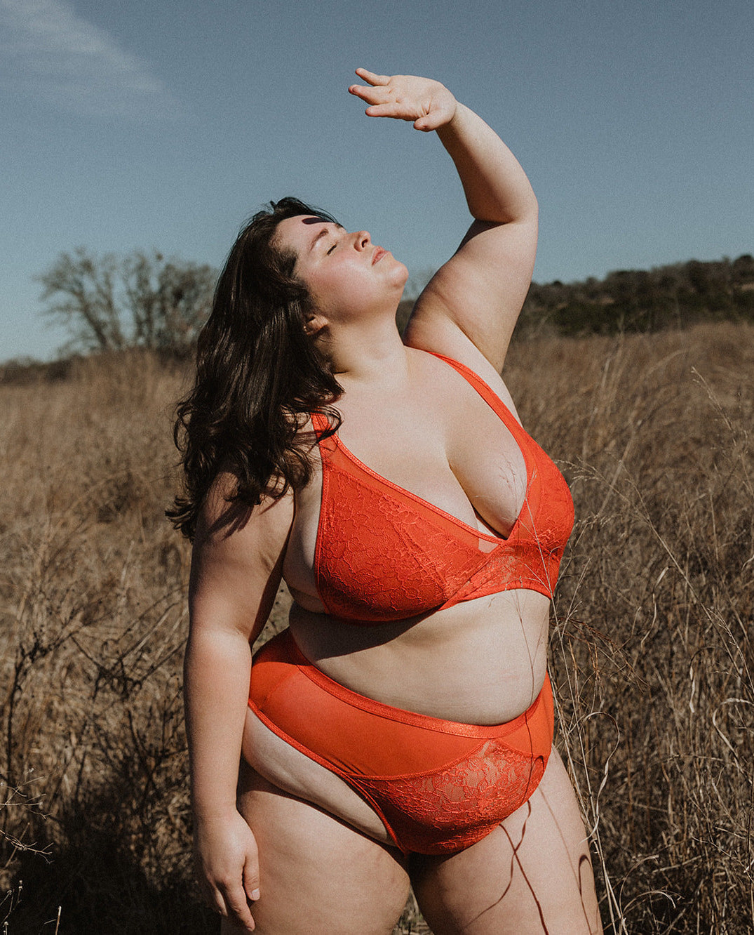 Model wearing orange lingerie set