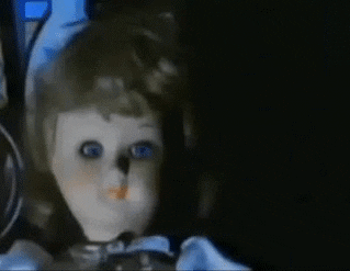 a creepy china doll with its eyes moving on its own