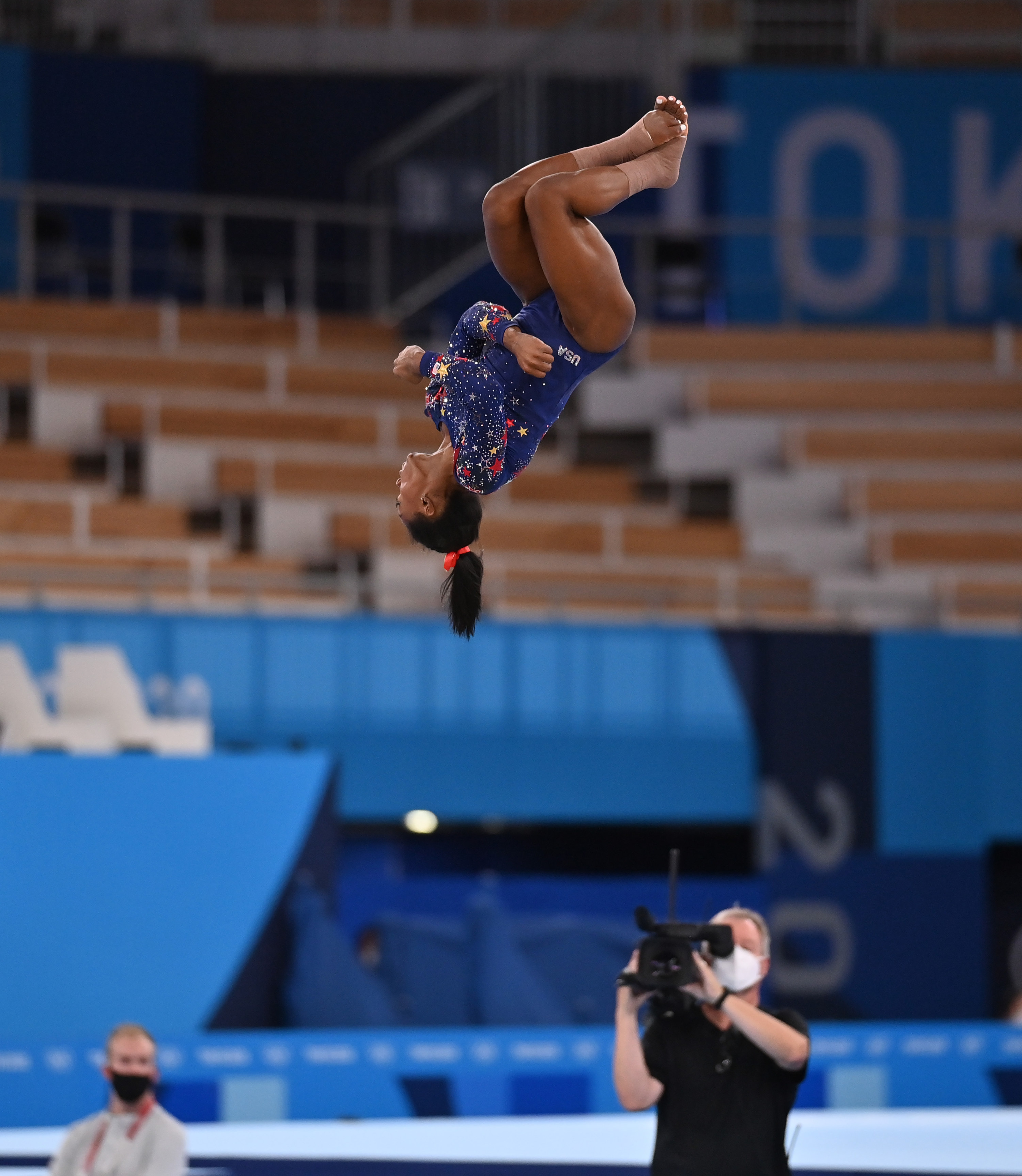 Simone is airborne and upside down