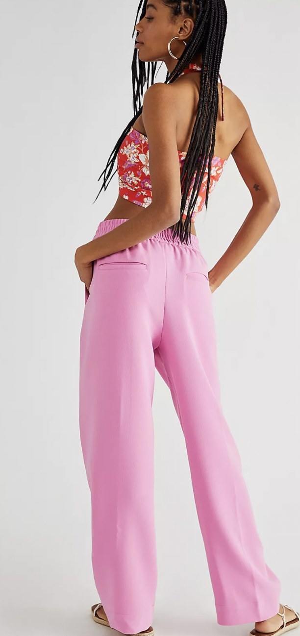 a model wearing the track pants in hot pink