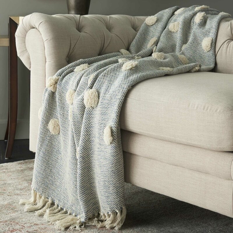blue and cream cotton throw with fluffy cotton dots