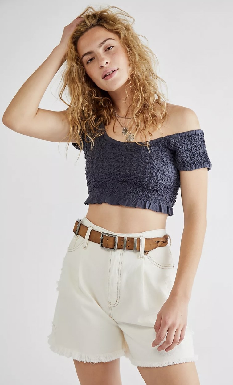 a model wearing the crop top in navy