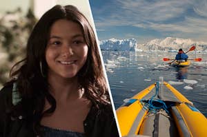 A close up of Izzie as she smiles brightly and two kayaks float through an icy ocean