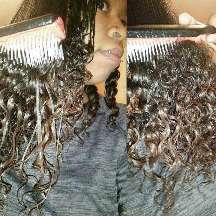 reviewer using brush in conditioned curls