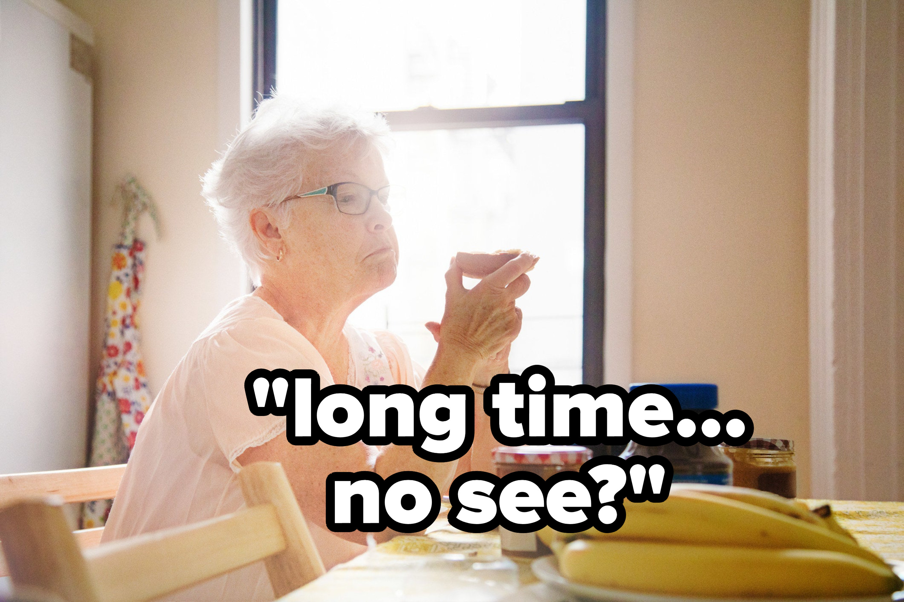 An older woman sitting at a table with the caption &quot;Long time...no see?&quot;