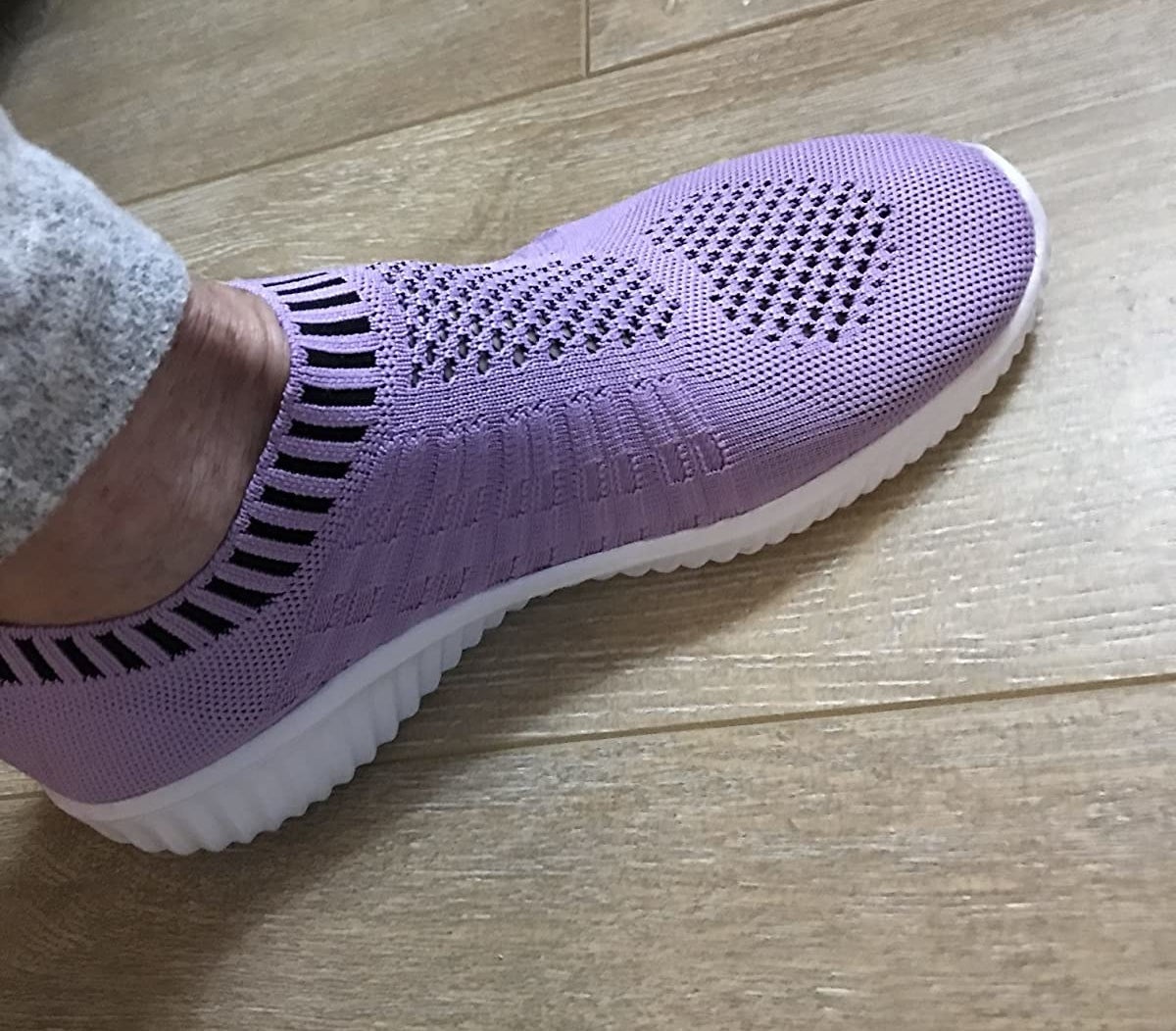 reviewer wearing the purple mesh sneakers