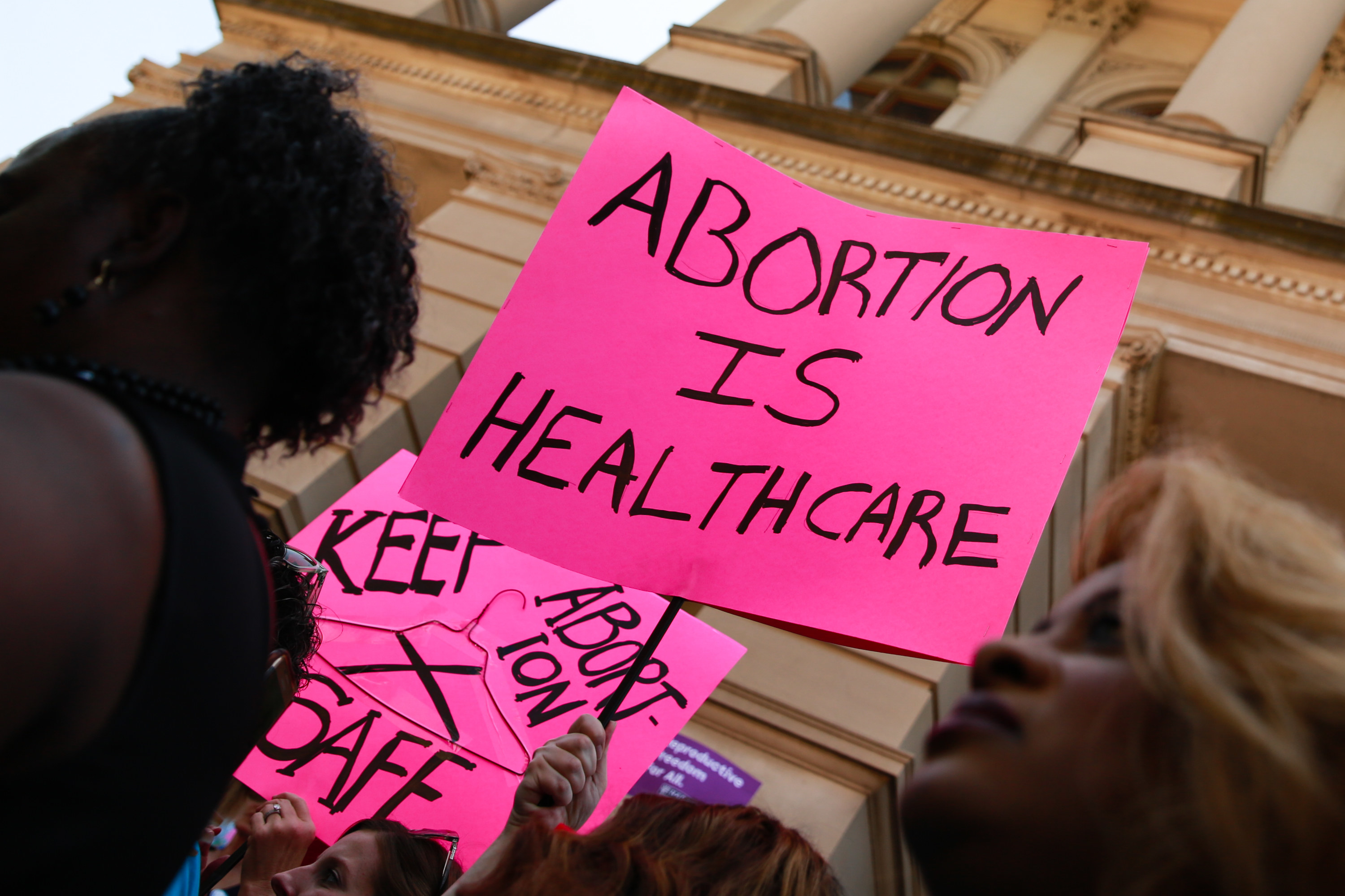 An image of a &quot;abortion is healthcare&quot; sign at a march
