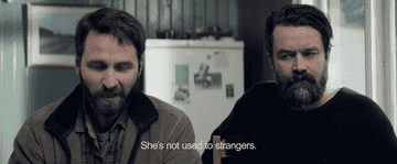 A man saying, &quot;she&#x27;s not used to strangers&quot; to a friend