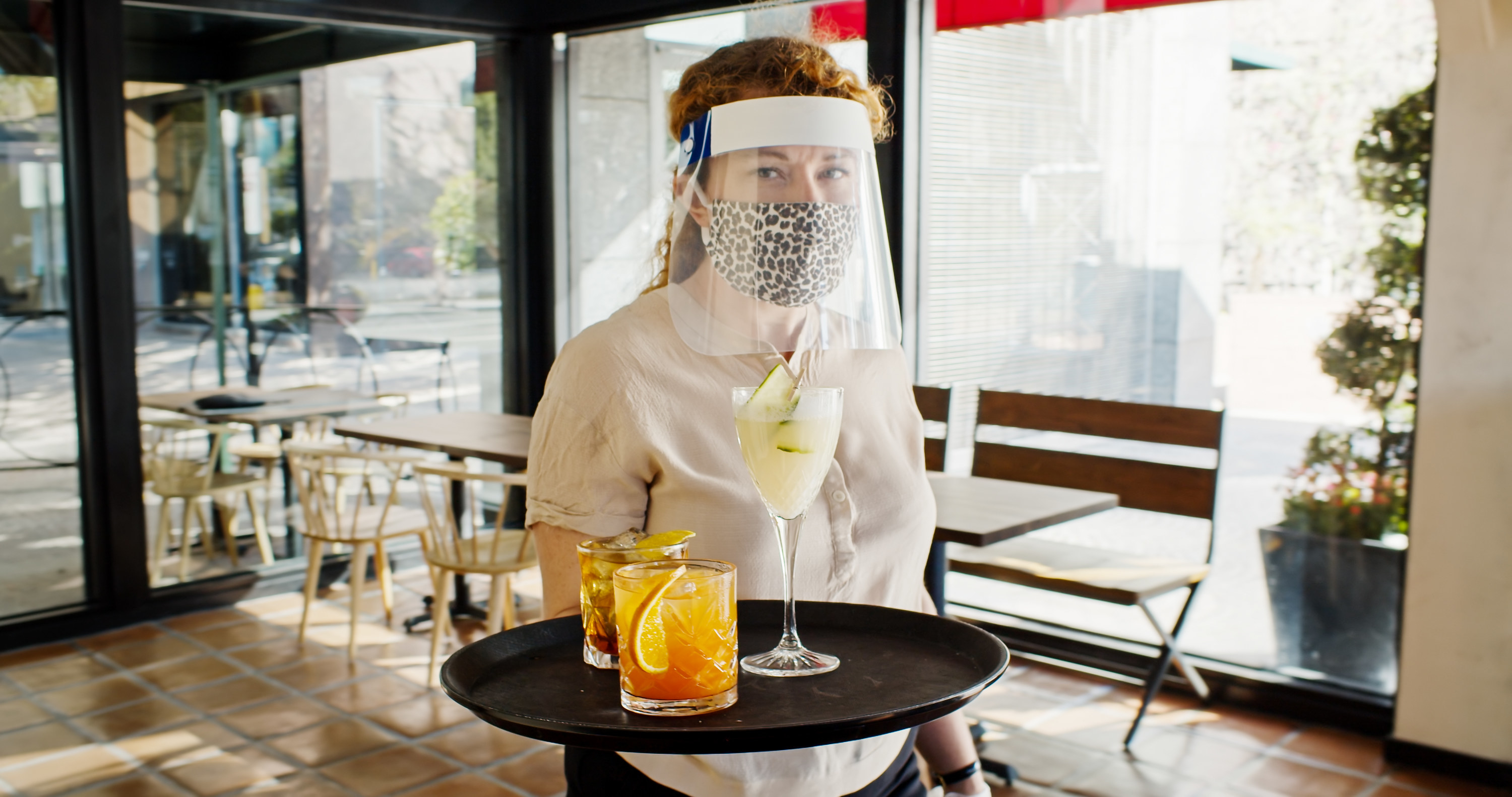 Restaurant server wearing a mask and face shield