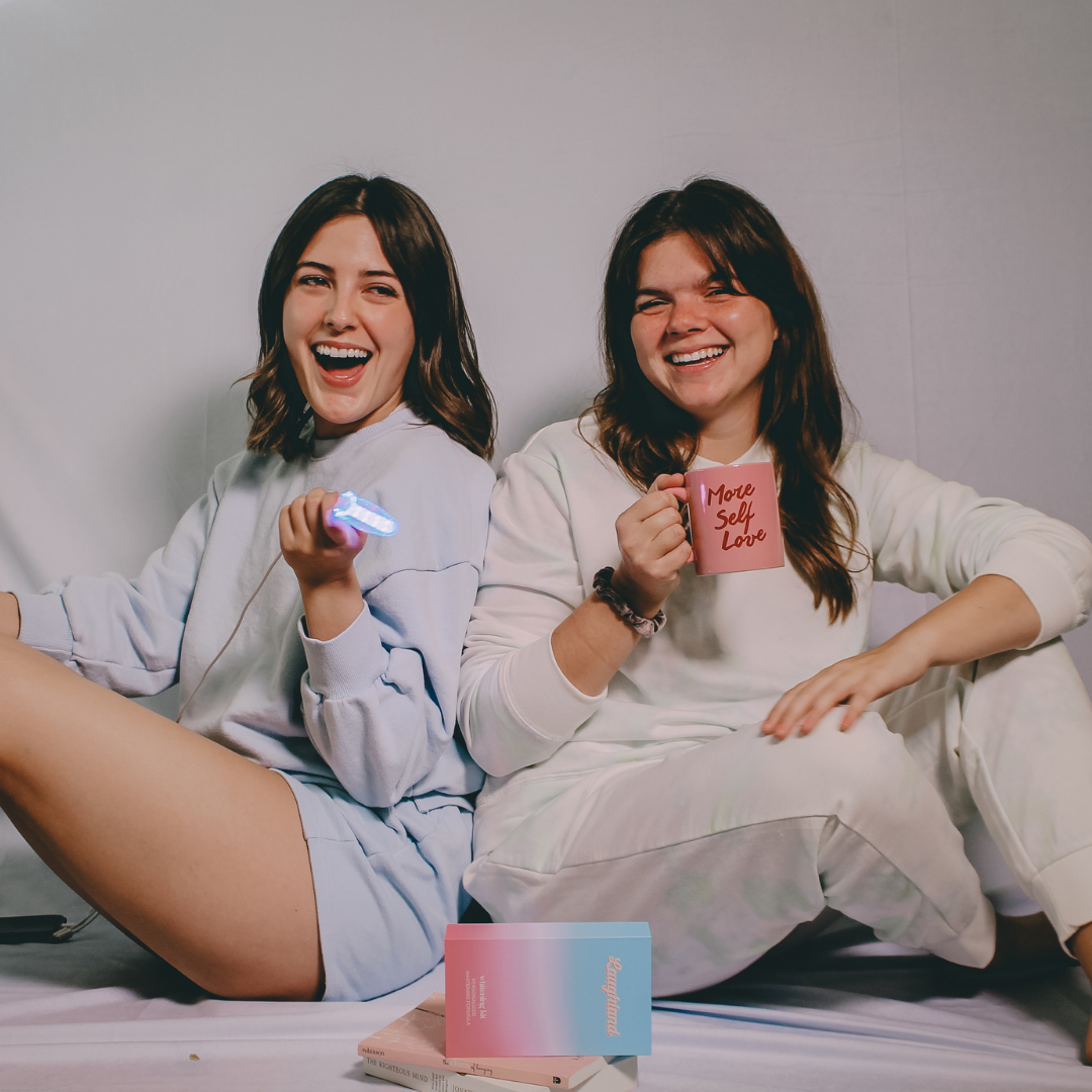 a model holding a laughland mouthpiece next to another model holding a mug