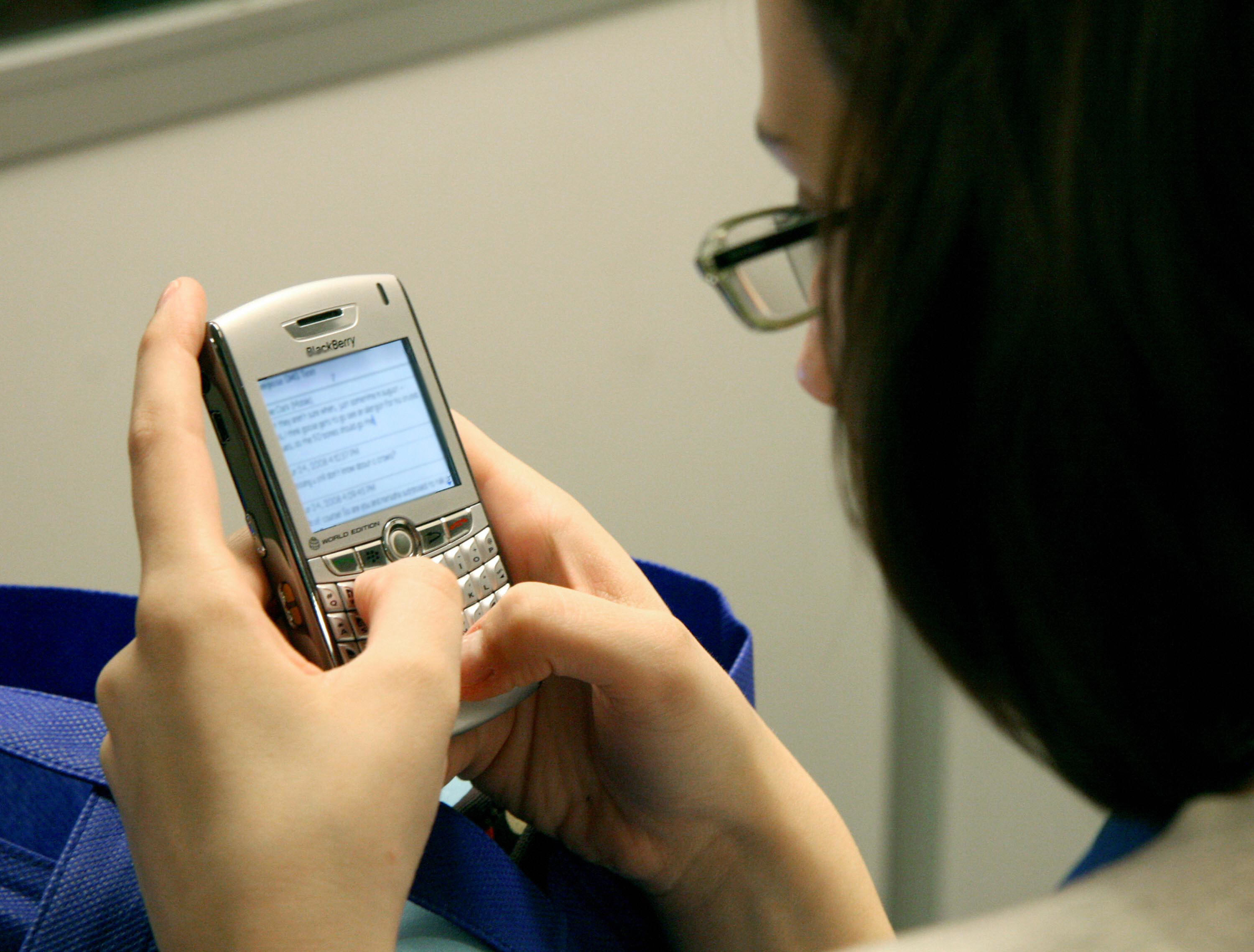 Photo of girl texting on her Blackberry