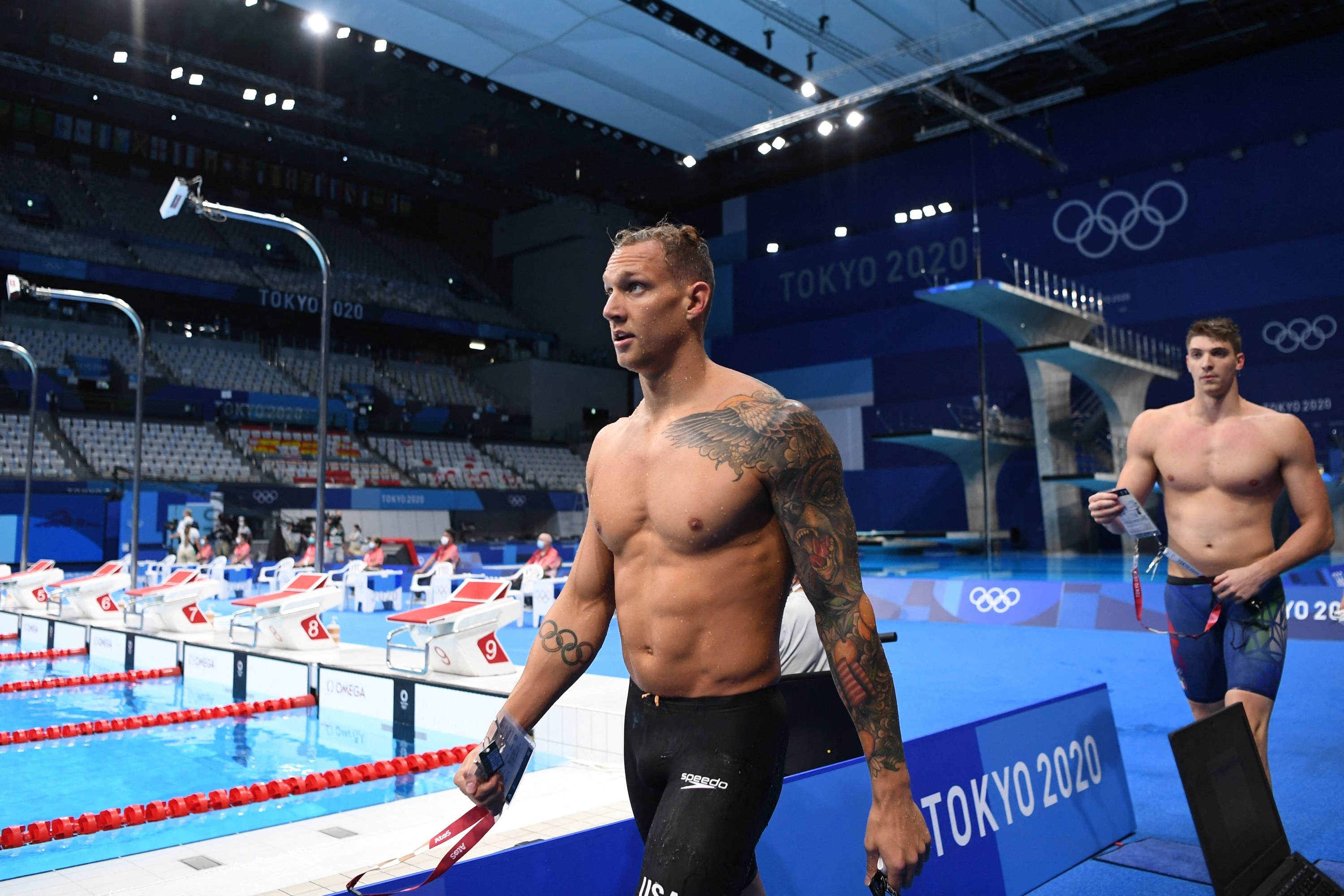 American male swimmer exits the pool area at the Olympics