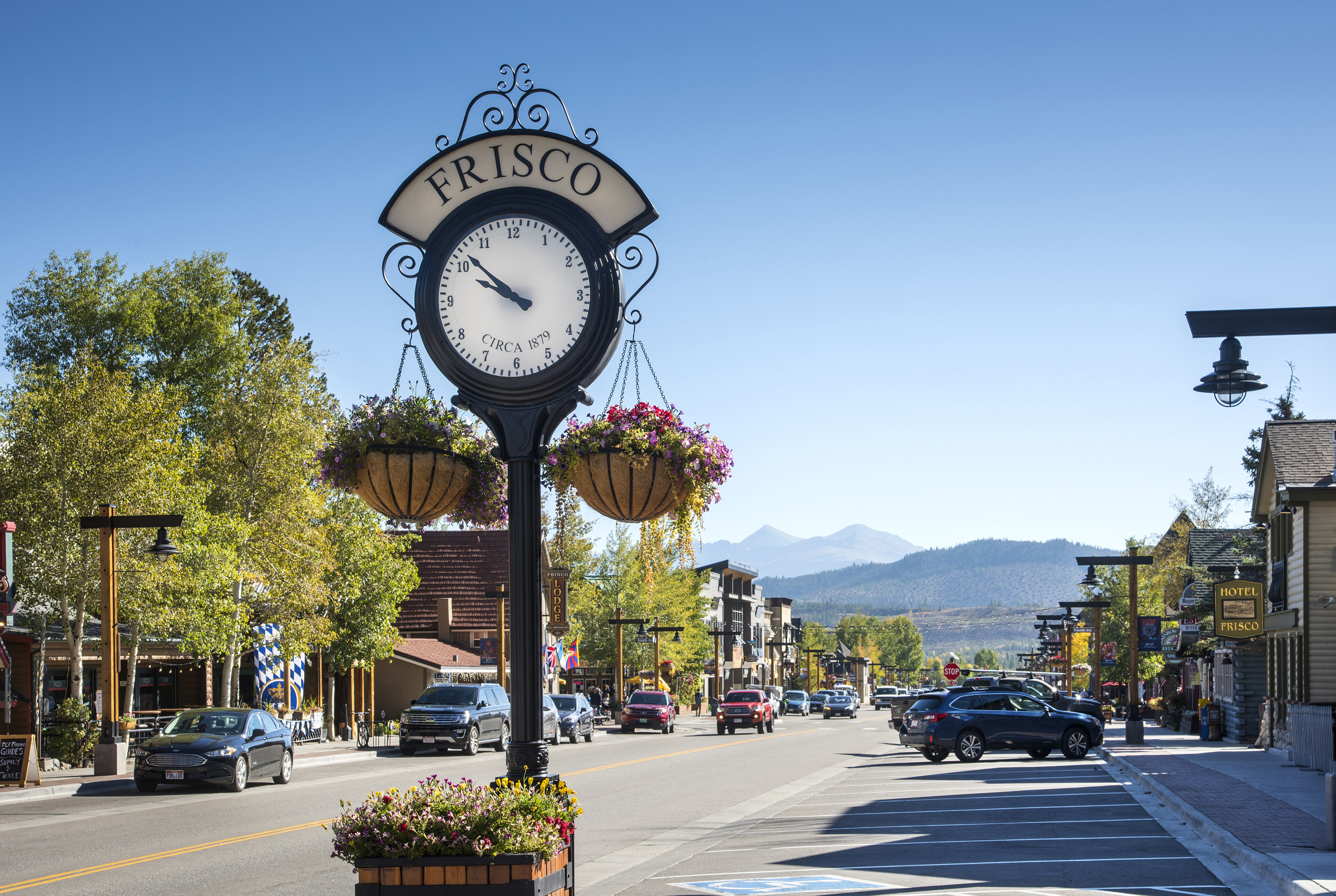 Clock on main street with mountains in the background
