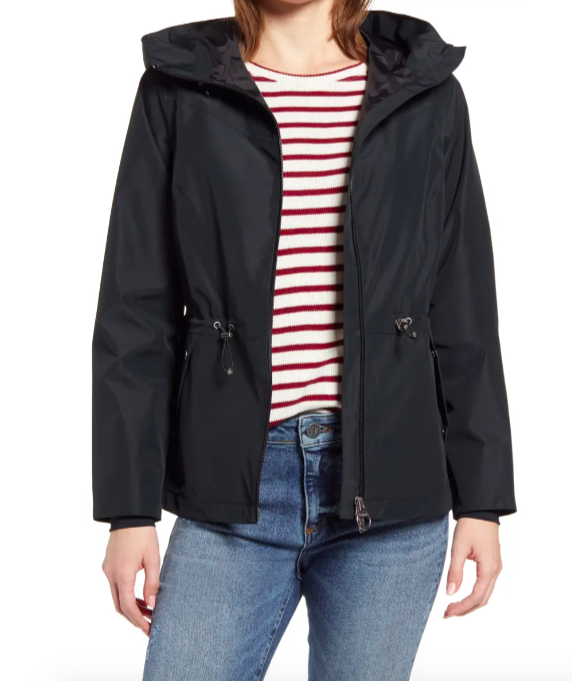 A model wearing the coat with jeans and striped shirt