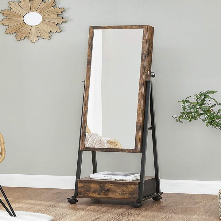 the mirror armoire in a bedroom next to a bright window