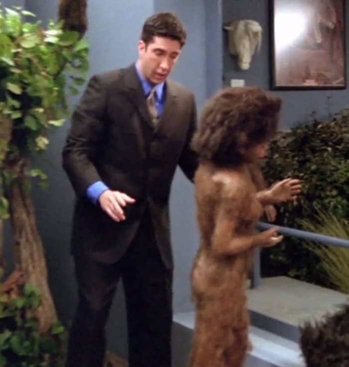 Ross adjusts a statue of a prehistoric male