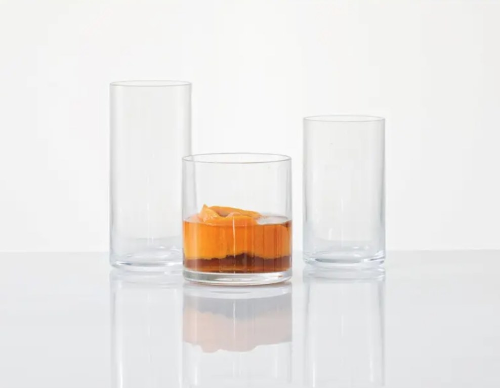 the whiskey glass with a cocktail in it in front of two larger glasses