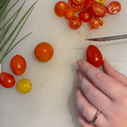 Gif of me slicing cherry tomatoes into tiny pieces easily with the knife 