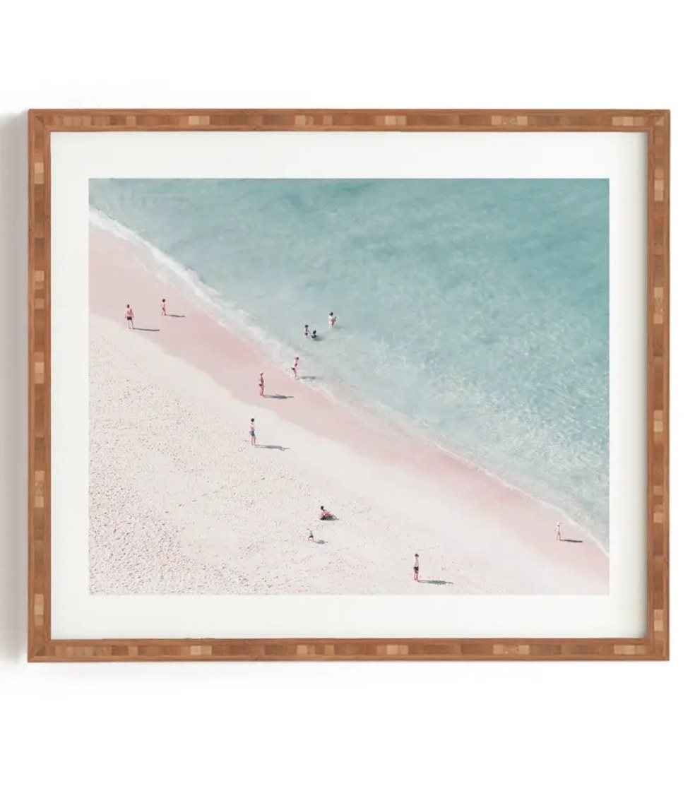 the print with people on a pink sand beach