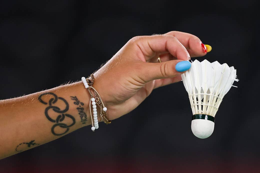 Close up of an Olympian holding a badminton birdie.