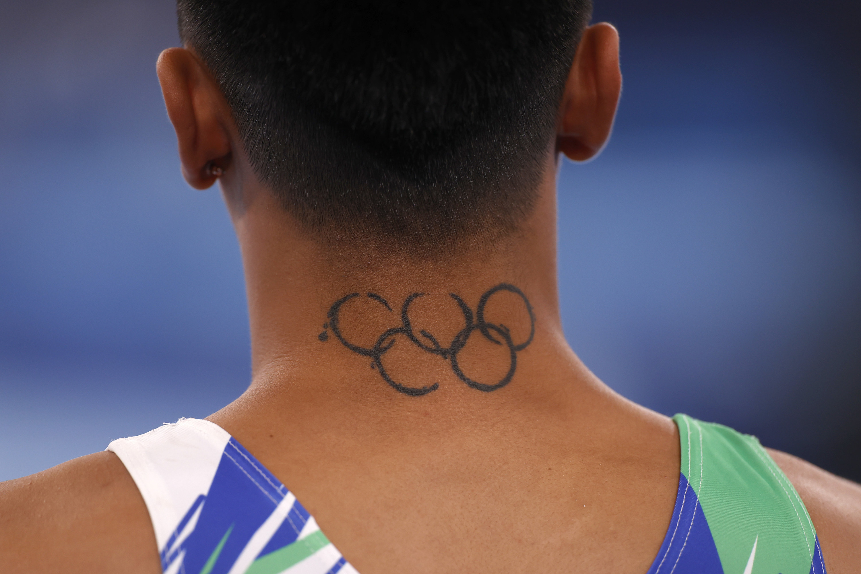 Close-up of Olympic male gymnast&#x27;s neck showing tattoo