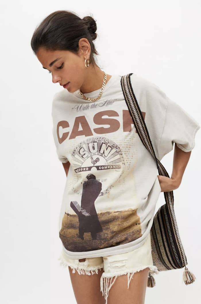 model wearing johnny cash t-shirt dress with cutoff jean shorts